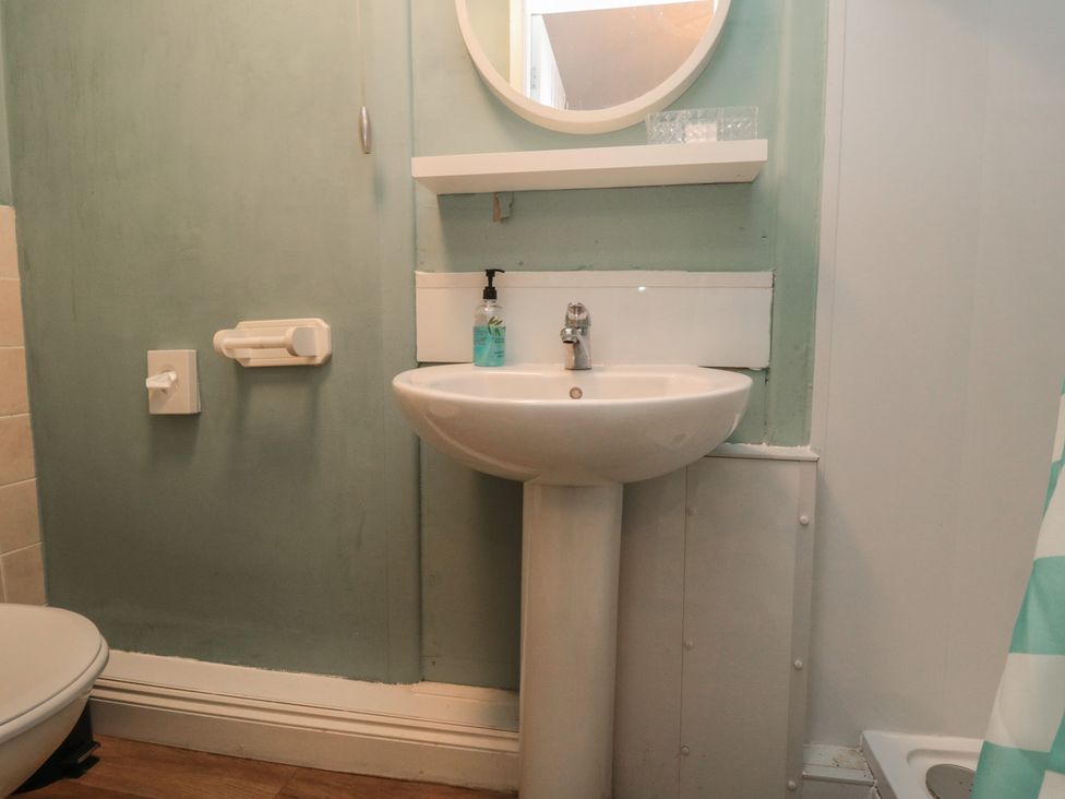 A bathroom with a sink and mirror at Meltham Guest House in Scarborough