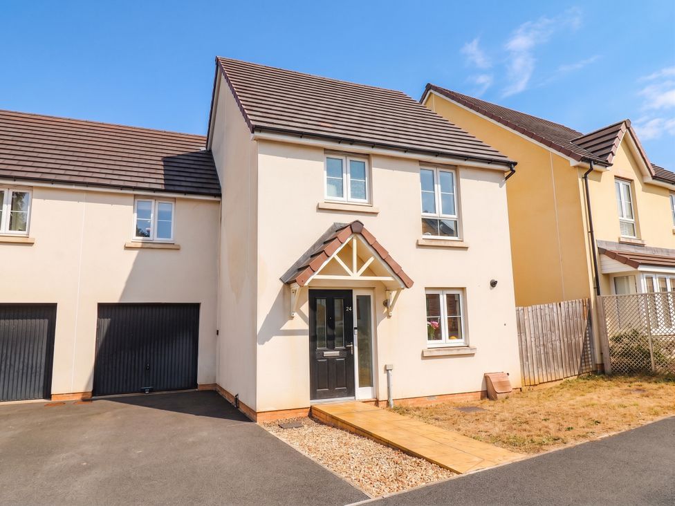 A house with a driveway and garden at 24 Higher Gorse Road in Roughton