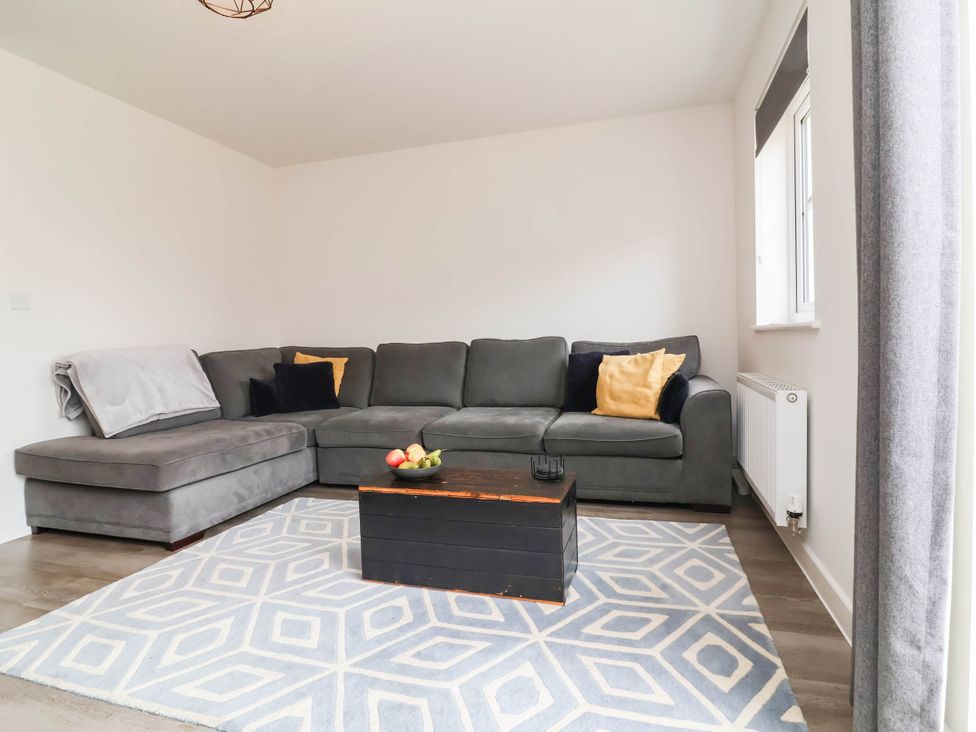 A living room with a sectional sofa and a coffee table at 24 Higher Gorse Road in Roughton