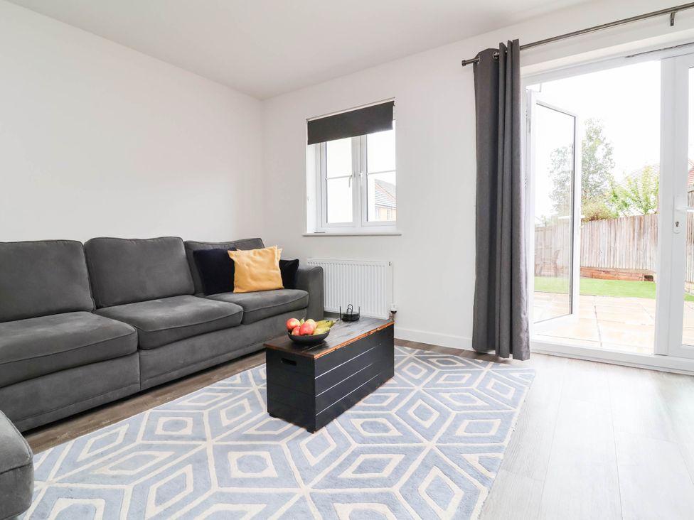 A living room with a sofa and coffee table at 24 Higher Gorse Road in Roughton
