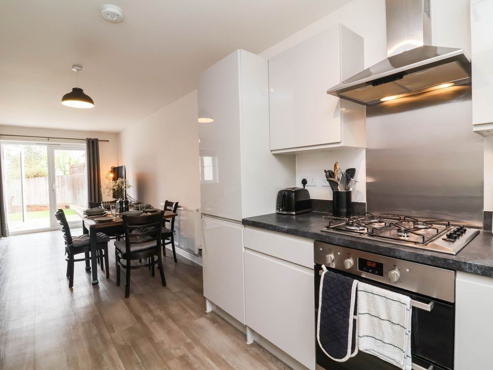 A kitchen with an island and dining area at 24 Higher Gorse Road in Roughton