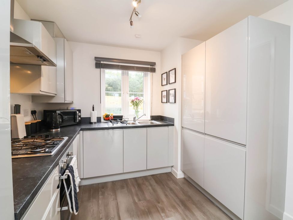 A kitchen with a sink and cabinets at 24 Higher Gorse Road in Roughton