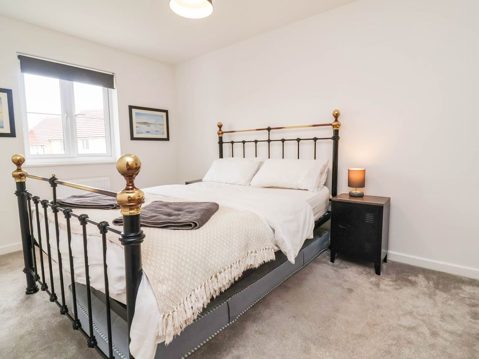 A bedroom with a bed and a nightstand at 24 Higher Gorse Road in Roughton