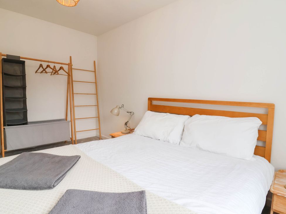 A bedroom with a bed and clothing storage at 24 Higher Gorse Road in Roughton