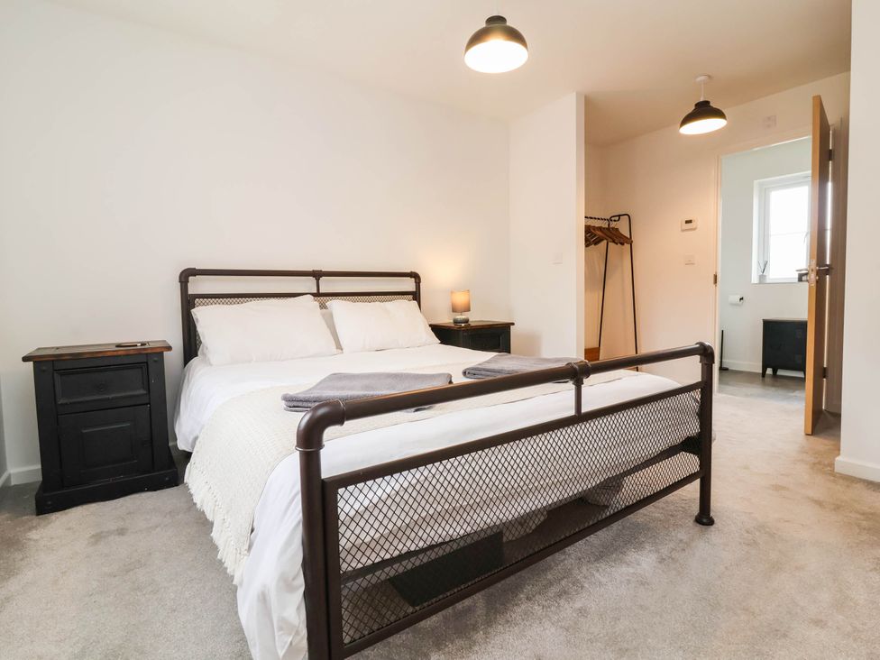 A bedroom with a bed and nightstand at 24 Higher Gorse Road Roughton