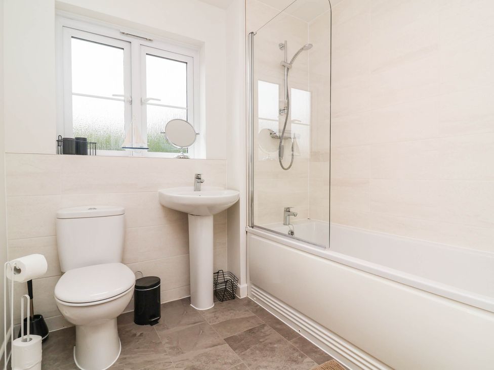 A bathroom with a bath, toilet, and sink at 24 Higher Gorse Road Roughton