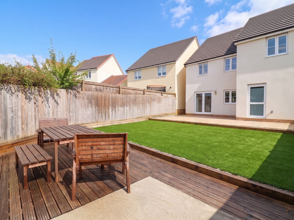 A garden with a wooden table and chairs at 24 Higher Gorse Road Roughton