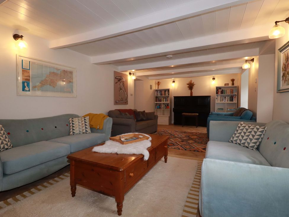 A living room with sofas and bookshelves at Seveock in Threemilestone