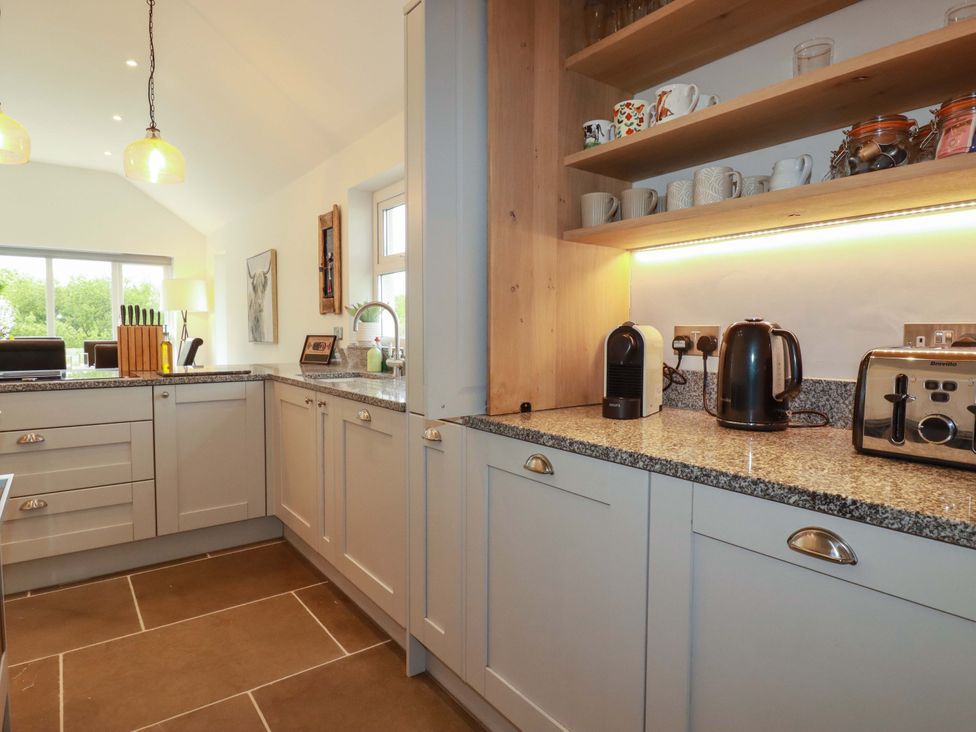 A kitchen with appliances and cupboards at Seveock in Threemilestone