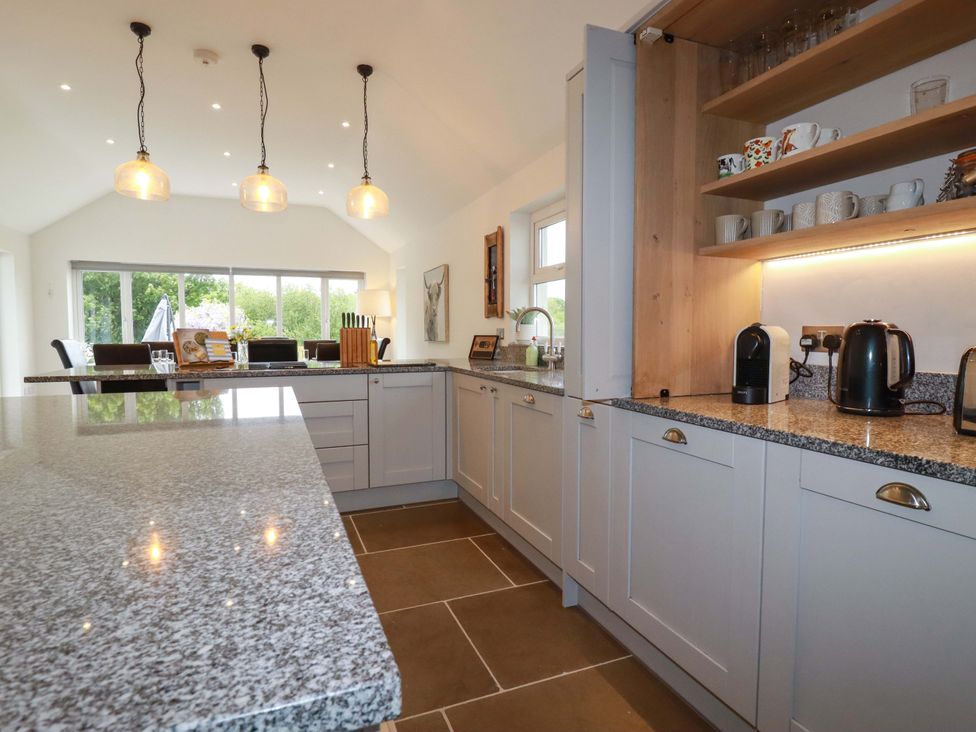 A kitchen with cabinets and an island at Seveock in Threemilestone