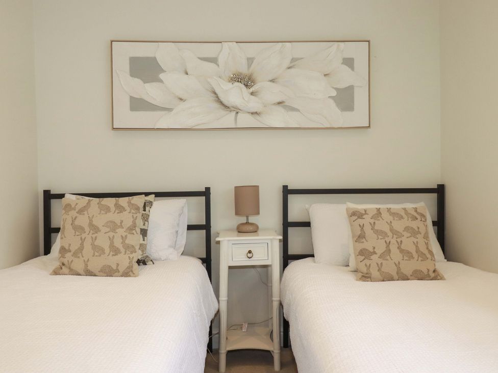 A bedroom with two beds and a nightstand at Seveock in Threemilestone