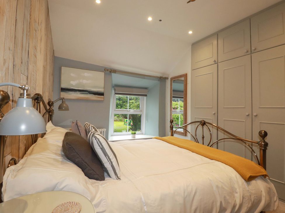 A bedroom with a bed and wardrobe at Seveock in Threemilestone