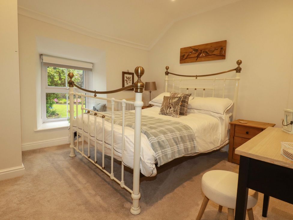 A bedroom with a bed and a desk at Seveock in Threemilestone
