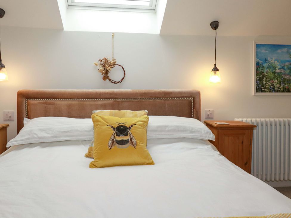 A bedroom with a bed and wall art at Seveock in Threemilestone