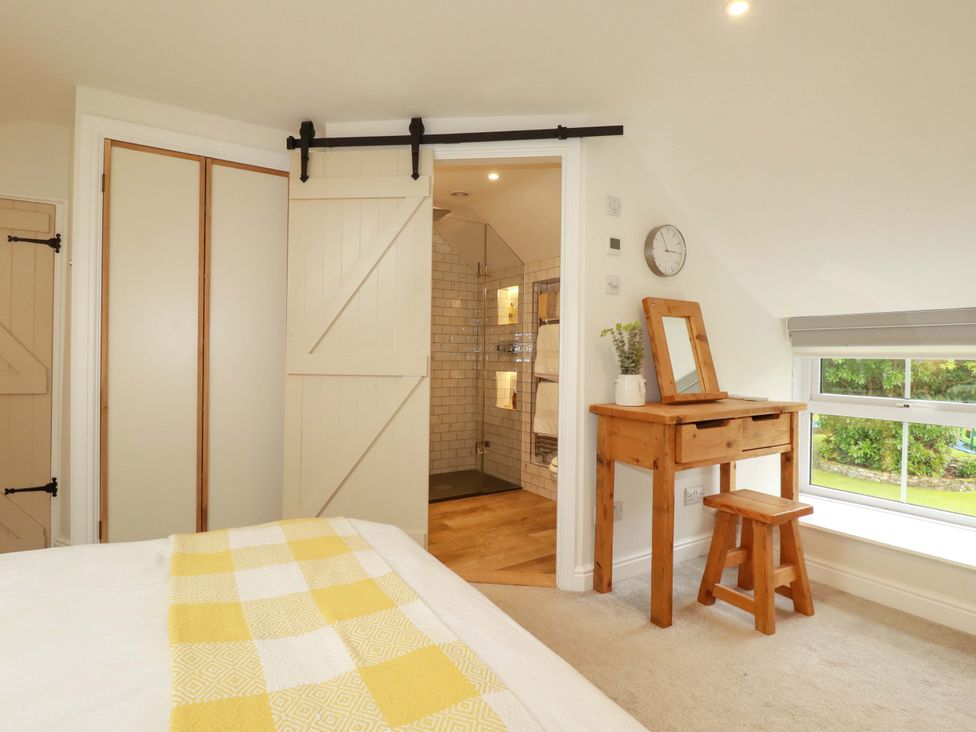 A bedroom with a bed and a shower room visible at Seveock in Threemilestone