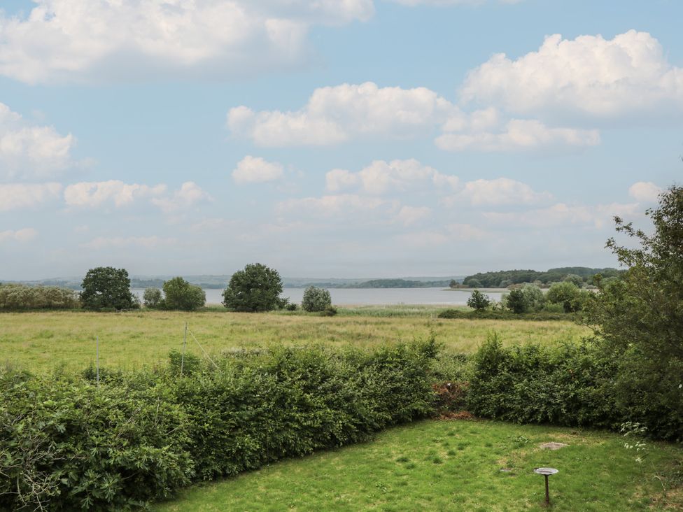 A view of a lake and trees near Herriots Bridge Cottage Annex near Bishop Sutton