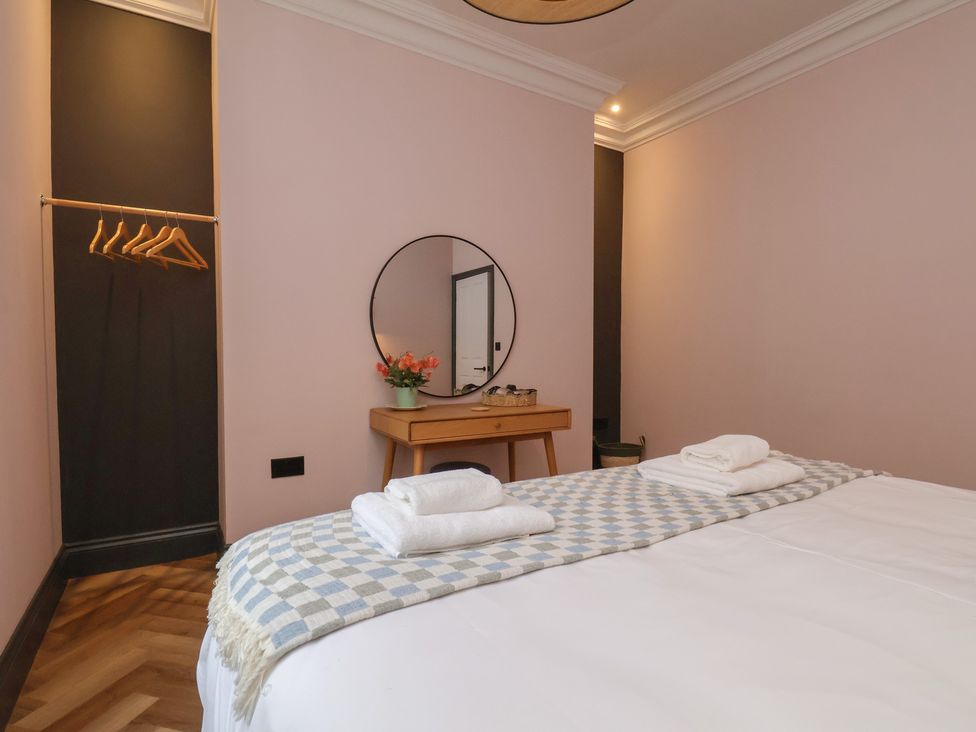 A bedroom with a bed and dresser at Apartment Pink in 