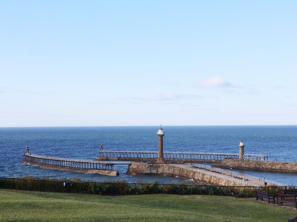 A view of a pier extending into the sea at Apartment Pink in Whitby