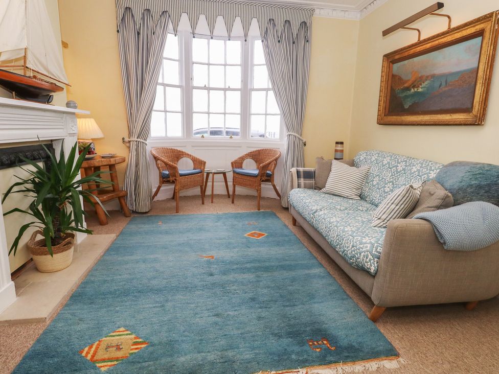 A living room with a couch and rug at No 3 By The Sea in Weymouth