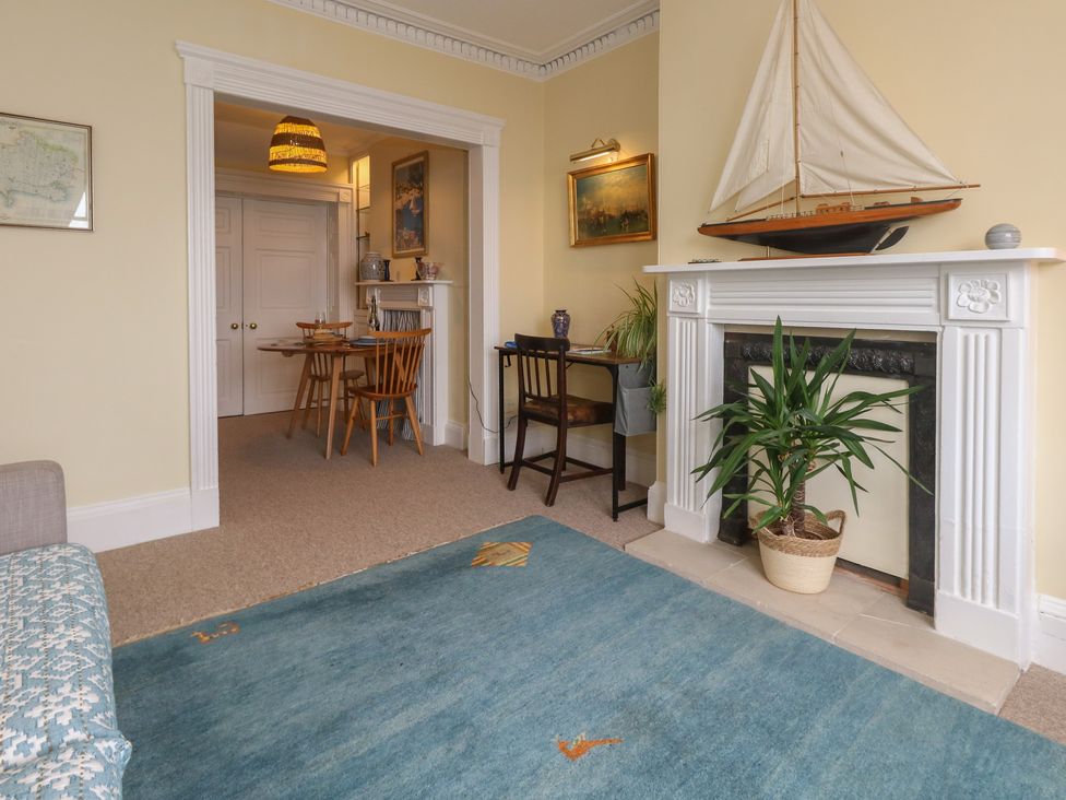A living room with a sofa and a fireplace at No 3 By The Sea in Weymouth