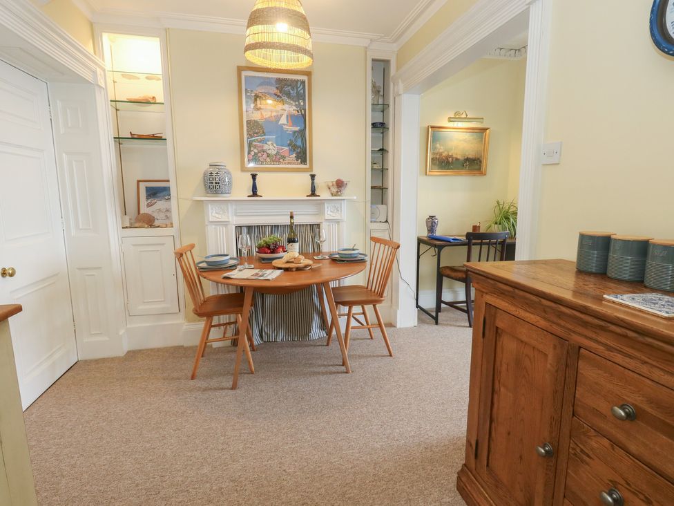 A dining room with a table and chairs at No 3 By The Sea in Weymouth