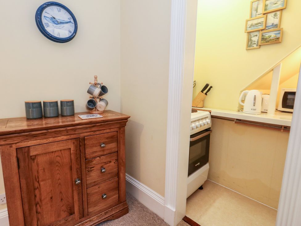 A kitchen area with a stove and appliances at No 3 By The Sea Weymouth