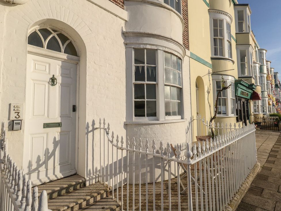A front entrance with a white door and windows at Number 3 by the Sea in Weymouth
