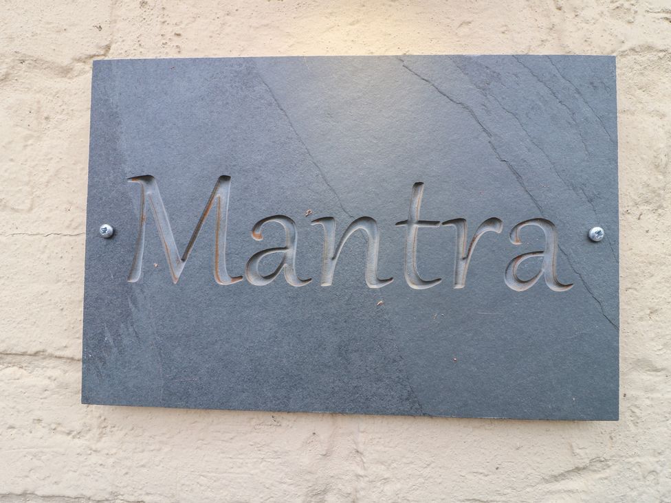 A slate sign with the word Mantra at Stay @ Mantra Stoke Albany