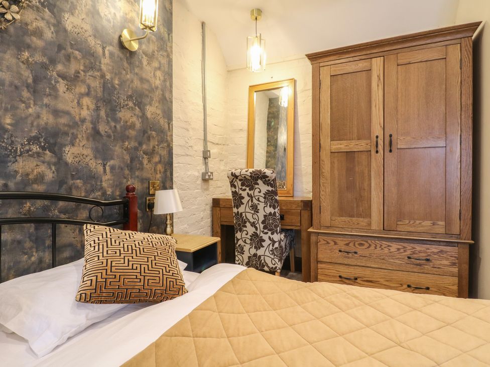 A bedroom with a bed, wardrobe, desk, and chair at Stay @ Mantra Stoke Albany