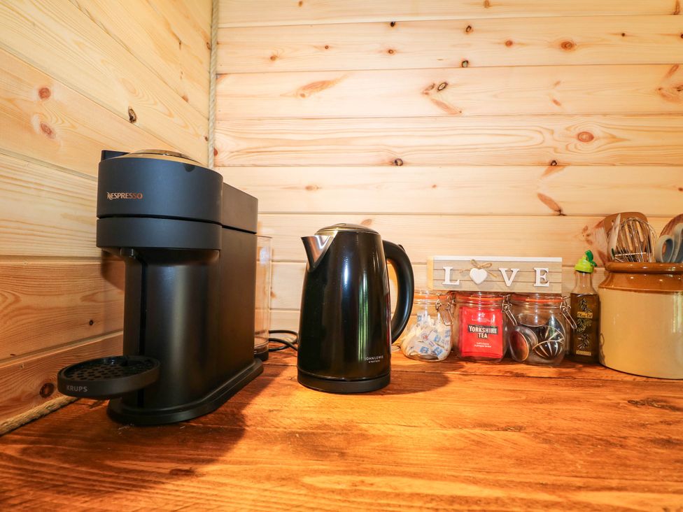 A kitchen counter with a Nespresso machine and kettle at Mallard Lodge in Marlow