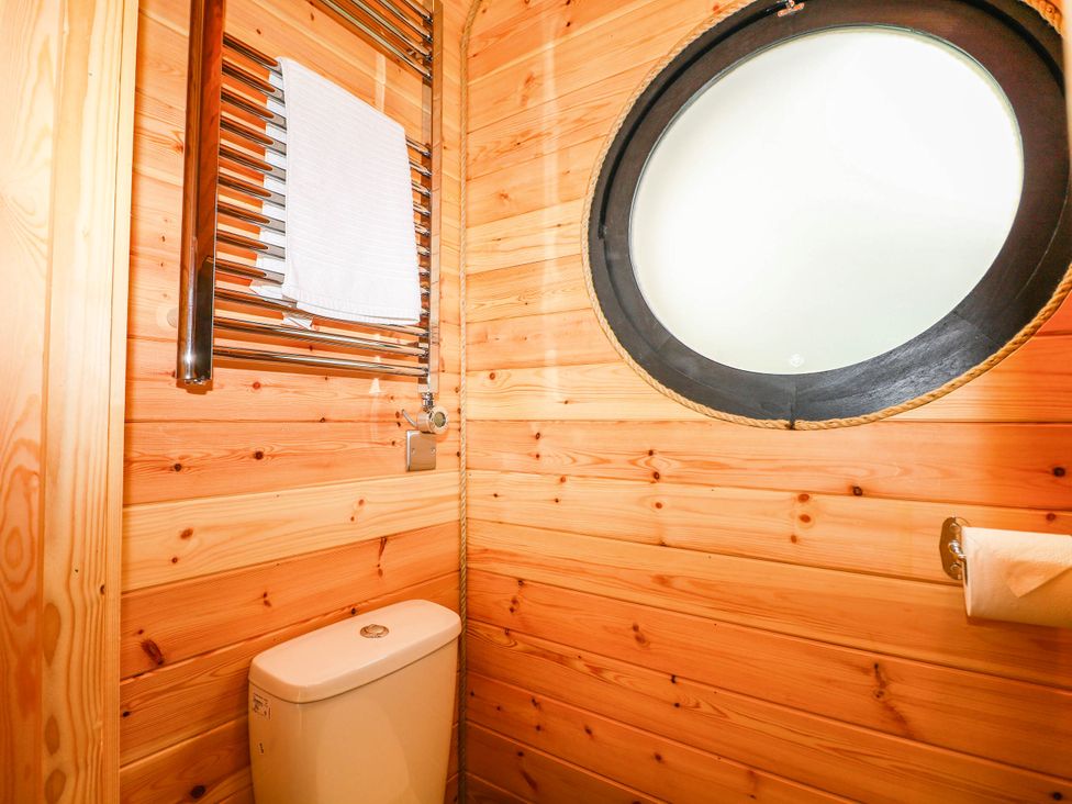 A bathroom with a toilet and towel rail at Mallard Lodge in Marlow