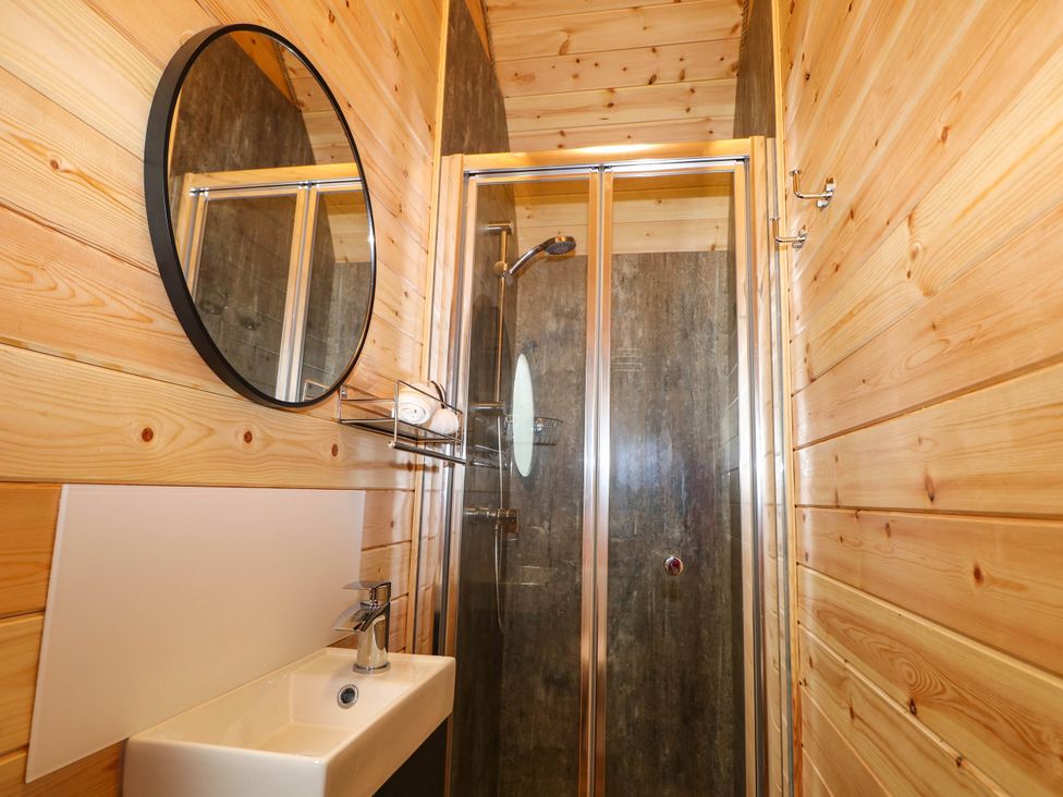 A bathroom with a shower and sink at Mallard Lodge in Marlow