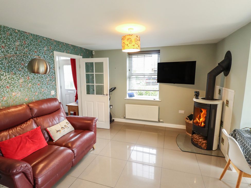 A living room with a sofa and a television at 26 Otho Way