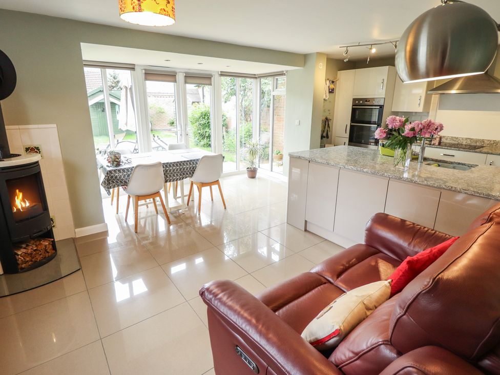 A kitchen with a dining table and sofa at 26 Otho Way