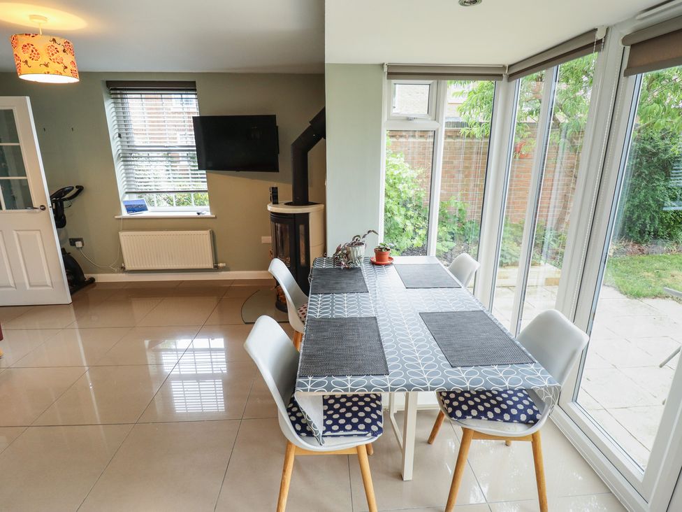 A dining room with a table and chairs at 26 Otho Way