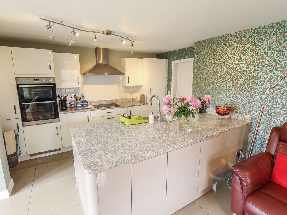 A kitchen with an island and appliances at 26 Otho Way