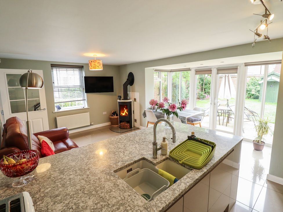 A kitchen with a dining area and sofa at 26 Otho Way