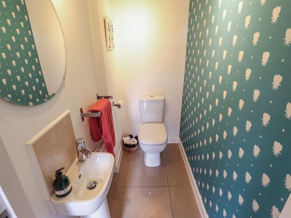 A small bathroom with a sink and toilet at 26 Otho Way