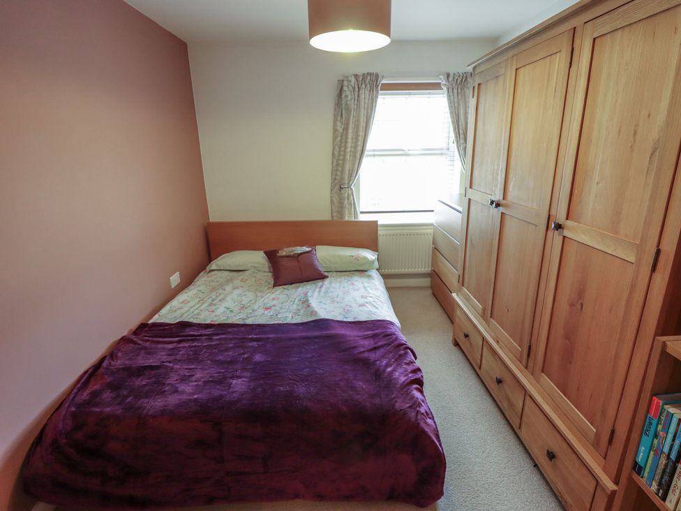 A bedroom with a bed and wardrobe at 26 Otho Way
