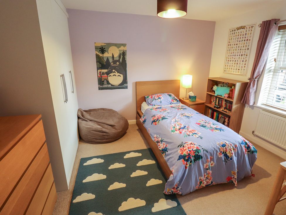 A bedroom with a bed and bookshelf at 26 Otho Way