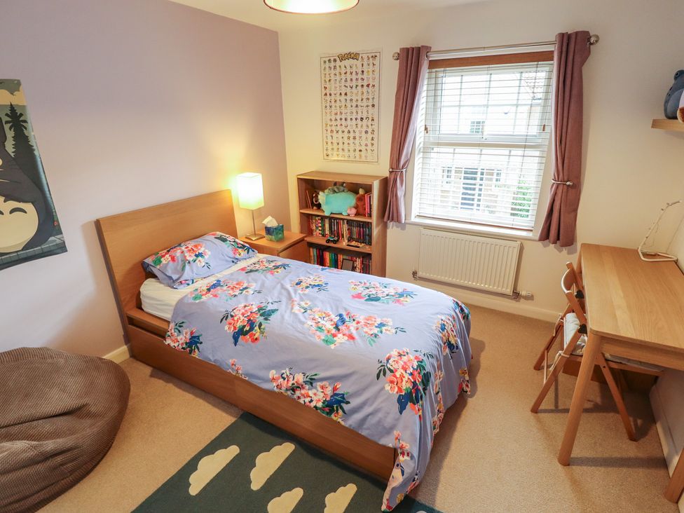 A bedroom with a bed and desk at 26 Otho Way