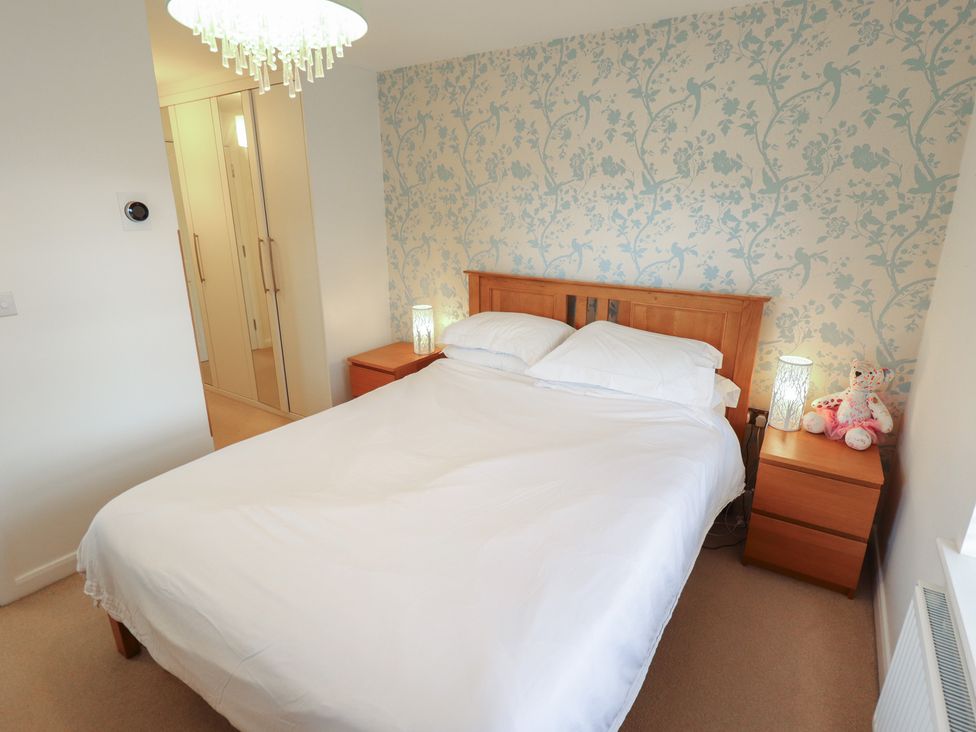 A bedroom with a bed and nightstand at 26 Otho Way
