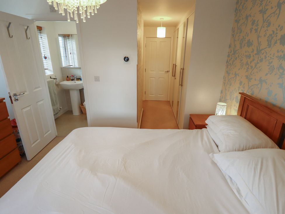 A bedroom with a bed and wardrobe at 26 Otho Way