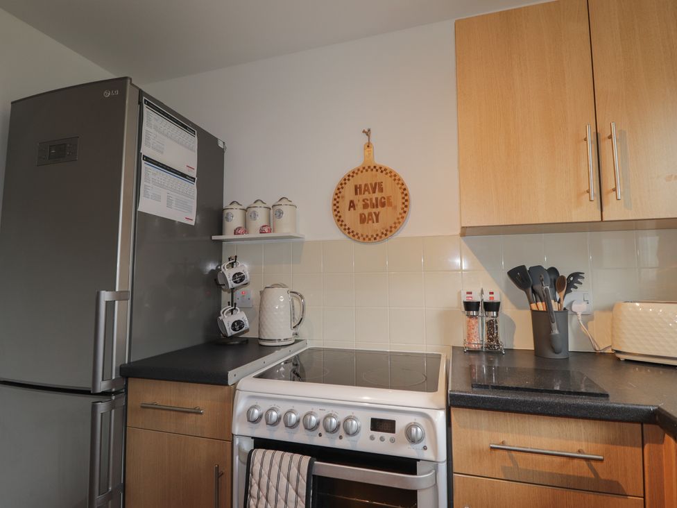 A kitchen with a refrigerator and an oven at 39 Knocknagael in Inverness