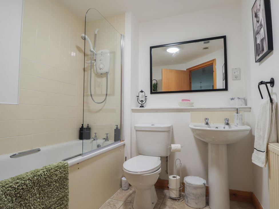A bathroom with shower and tub at 39 Knocknagael in Inverness