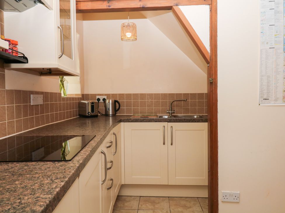 A kitchen with cabinets, sink and countertop at Gorway Cottage in Teignmouth