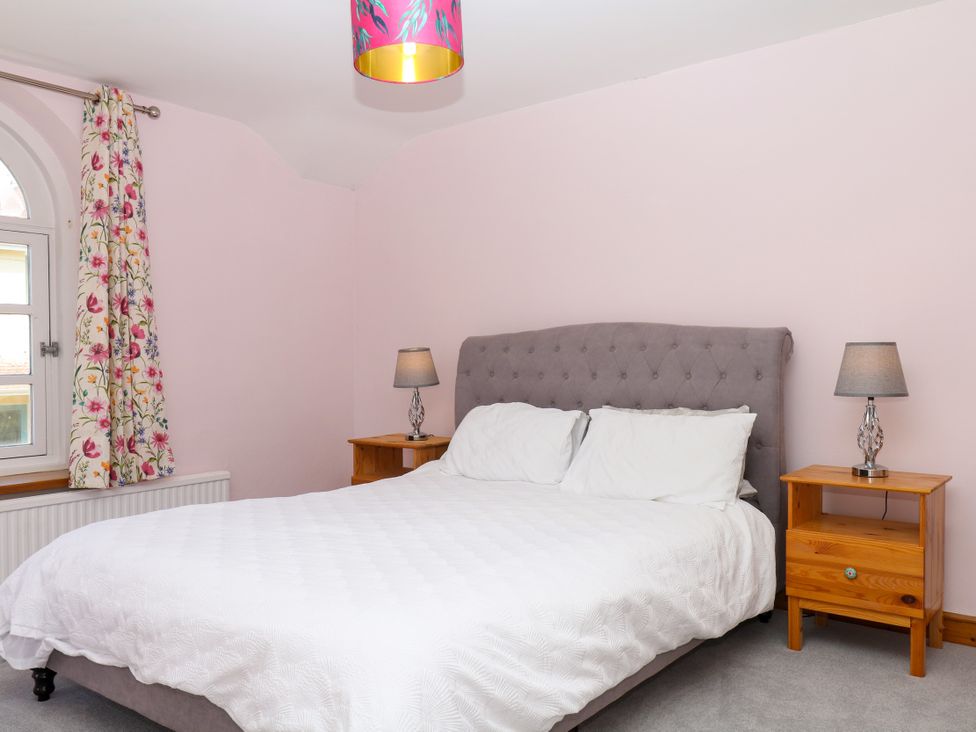 A bedroom with a bed and bedside tables at Gorway Cottage Teignmouth