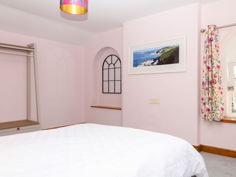 A bedroom with a bed and a window at Gorway Cottage in Teignmouth
