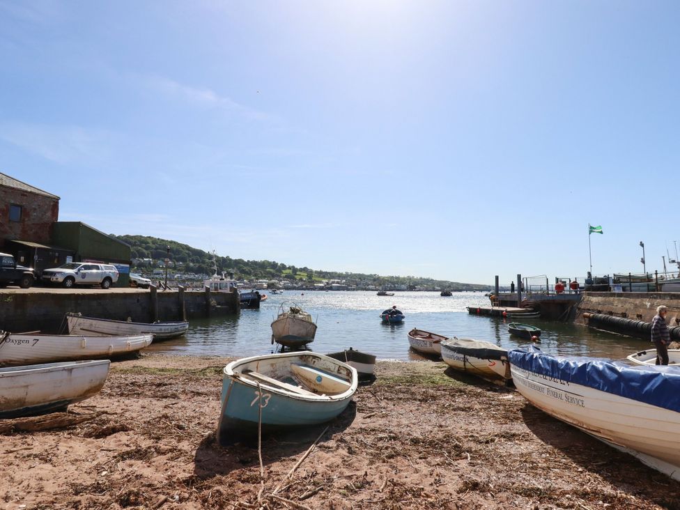 A view of boats at a waterfront with hills in the background at Gorway Cottage in Teignmouth