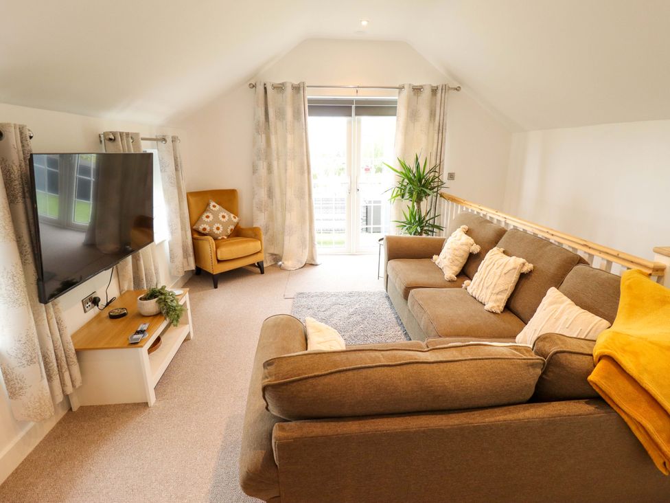 A living room with a sofa and television at The Hen House